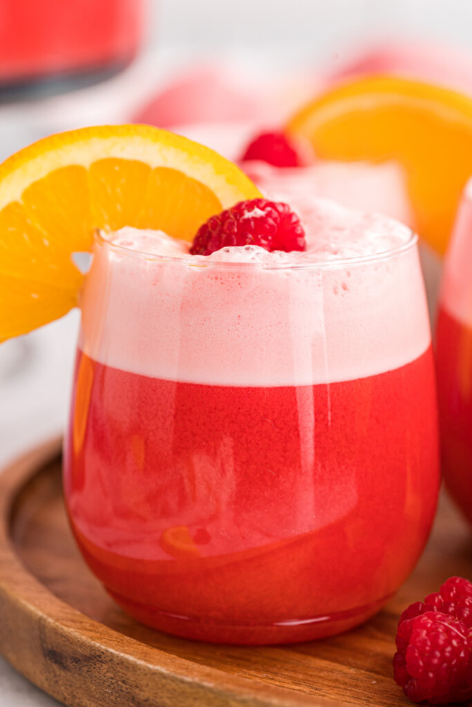 garnished sherbet party punch on wooden serving tray