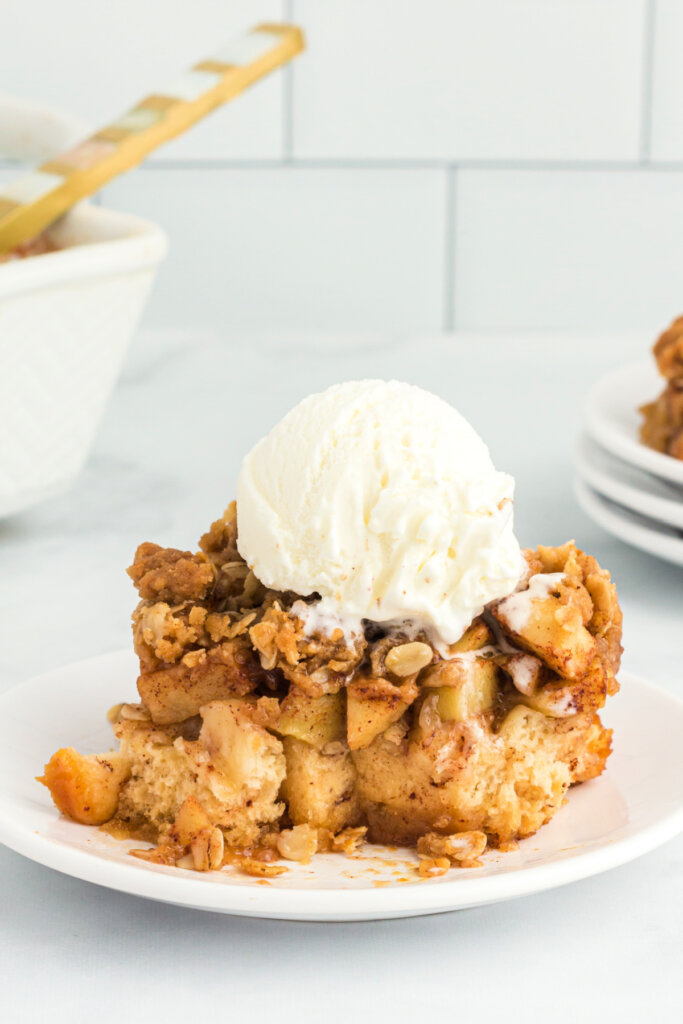 serving of apple cinnamon roll bake topped with vanilla ice cream