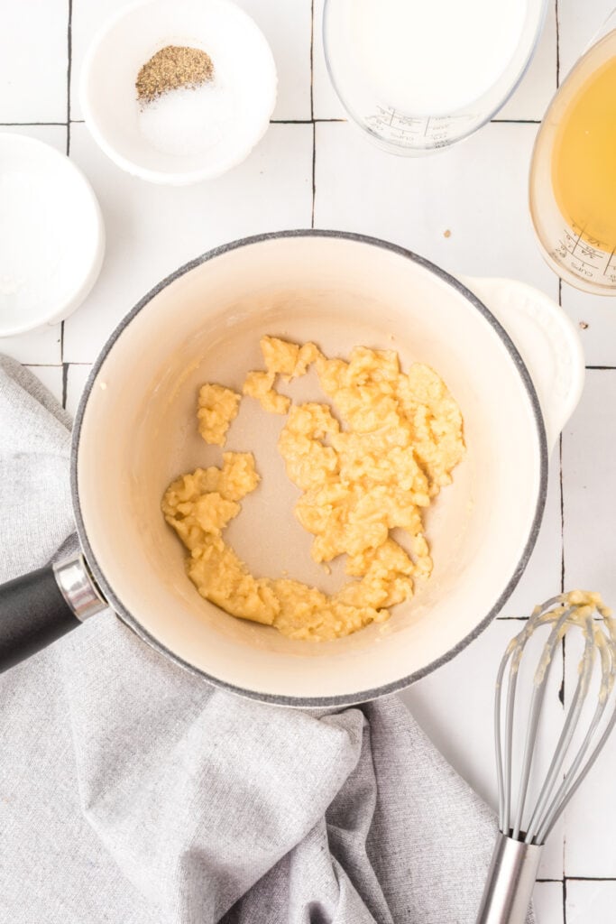 Butter and flour whisked together in a saucepan to form a roux.