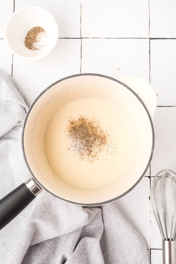 Salt and black pepper added to the creamy condensed soup mixture.