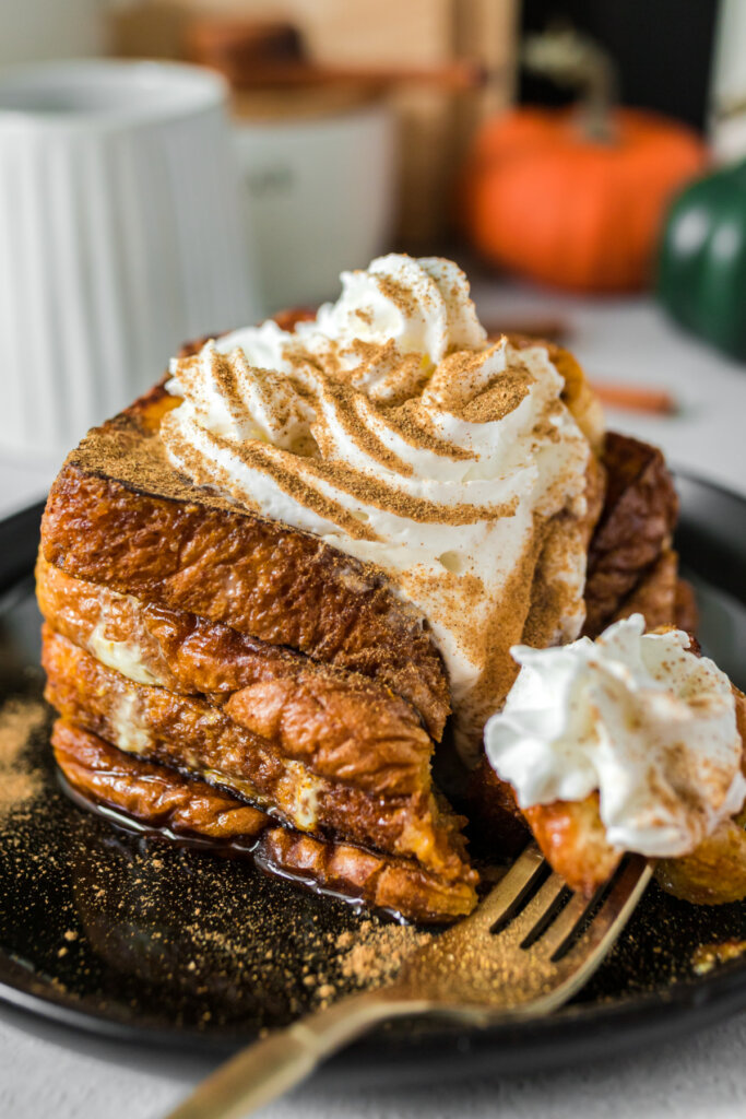 pumpkin spice frecnh toast on plate with a bite on fork