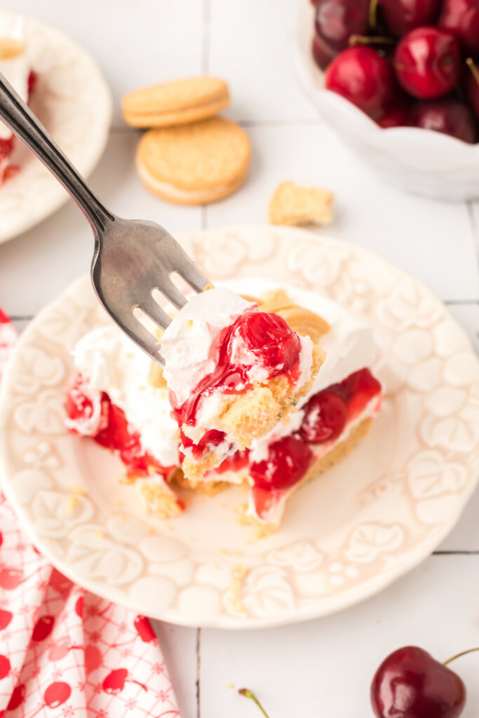 scooping a bite of cherry lasagna lush onto a fork