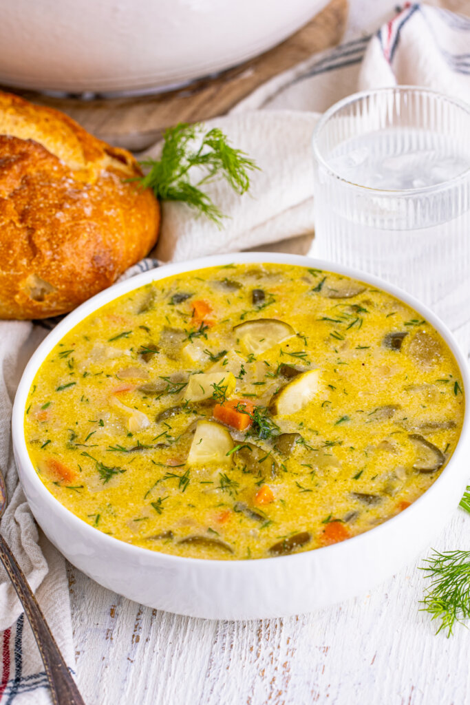 dill pickle soup in white bowl ready to eat