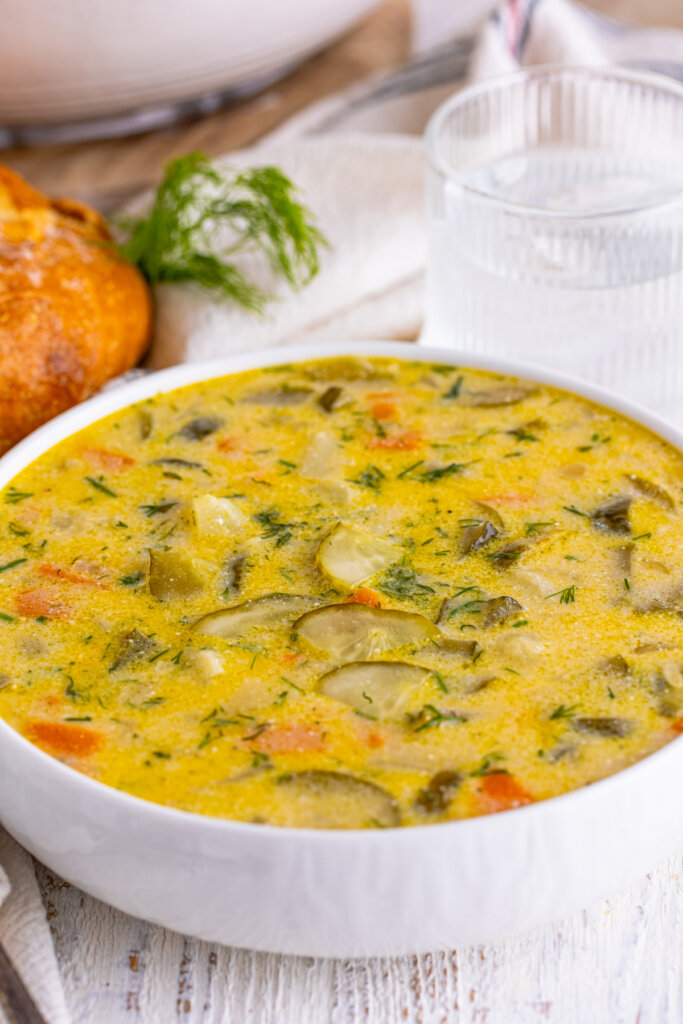 closeup of dill pickle soup in white bowl