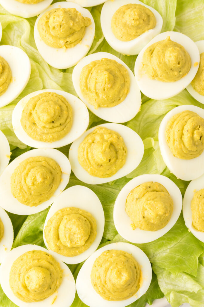 pesto deviled eggs on lettuce leaves