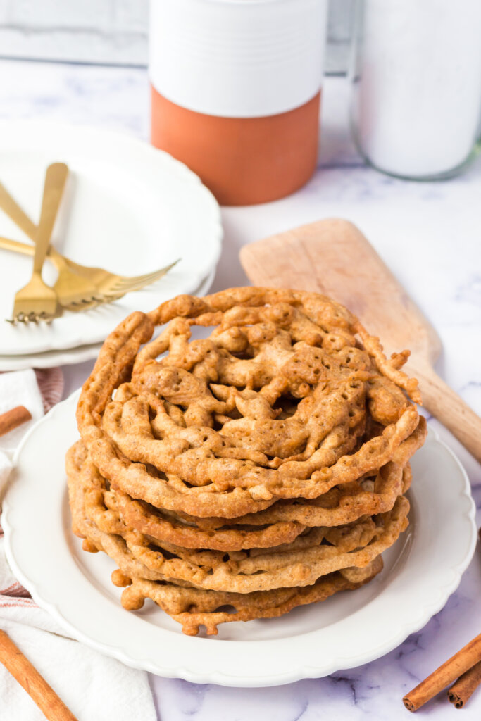 stack of pumpkin spice funnel cakes on plate