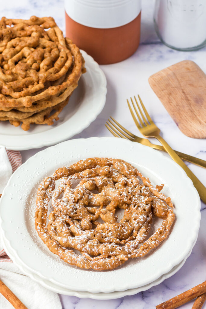 plate with a pumpkin spice funnel cake on it