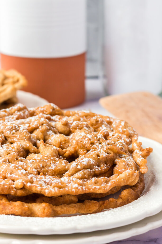 two funnel cakes on plate