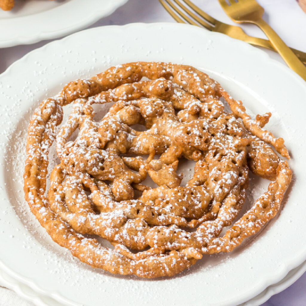 closeup of a pumpkin spice funnel cake on a plate