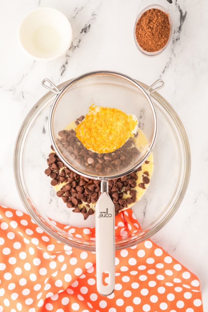 straining the mixture through a fine mesh sieve