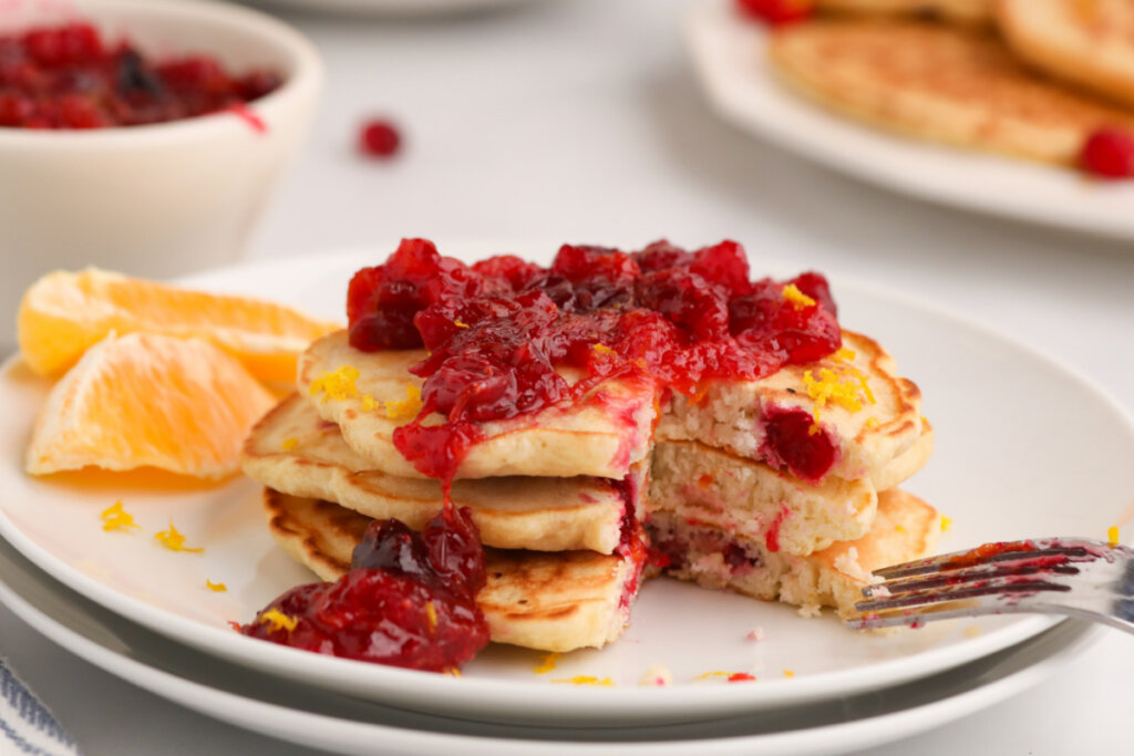 stack of three cranberry orange pancakes on plate