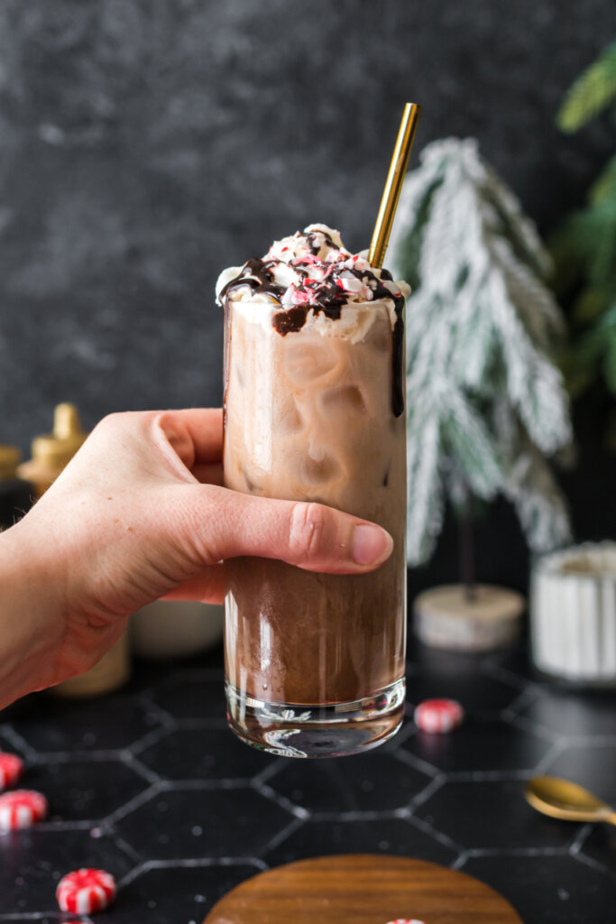 hand holding an iced peppermint mocha