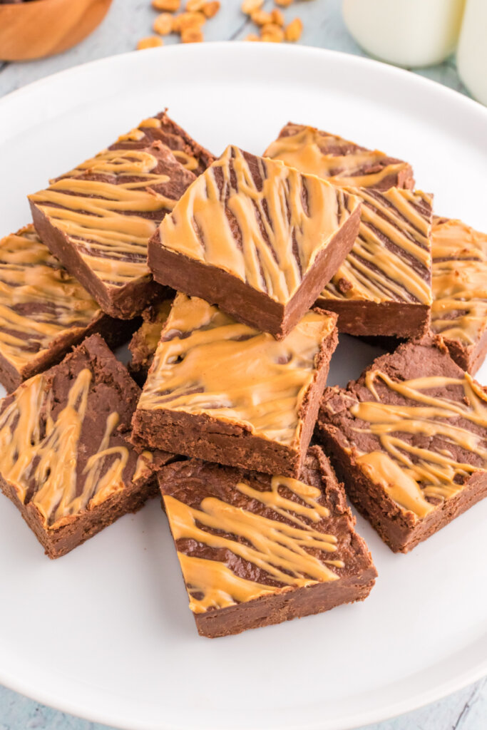 chocolate peanut butter fudge stacked on plate