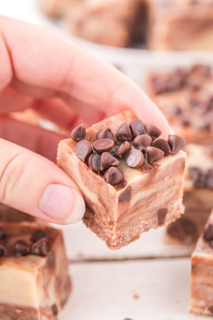 hand holding a piece of cookie dough fudge