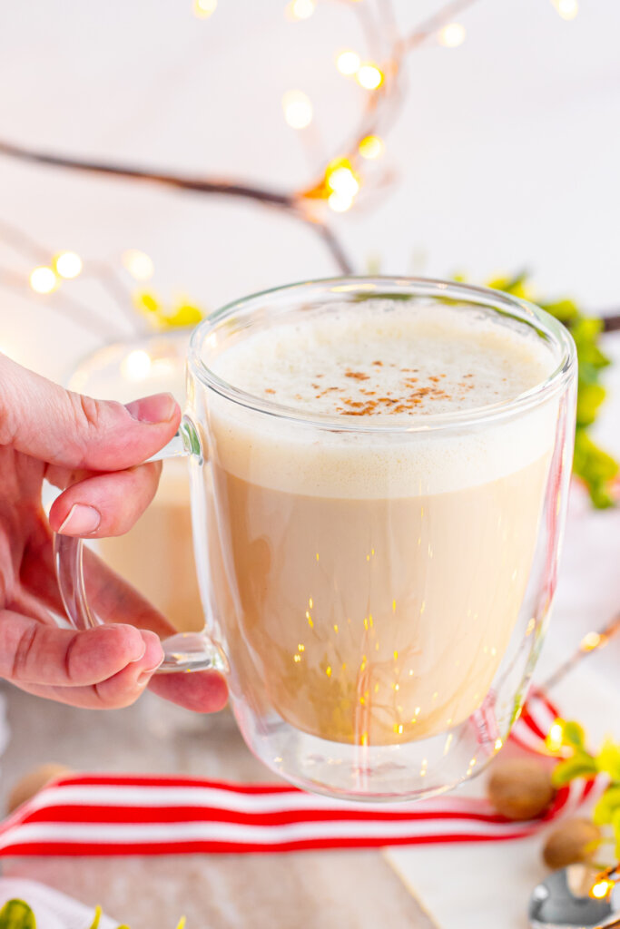 hand holding a mug of eggnog latte