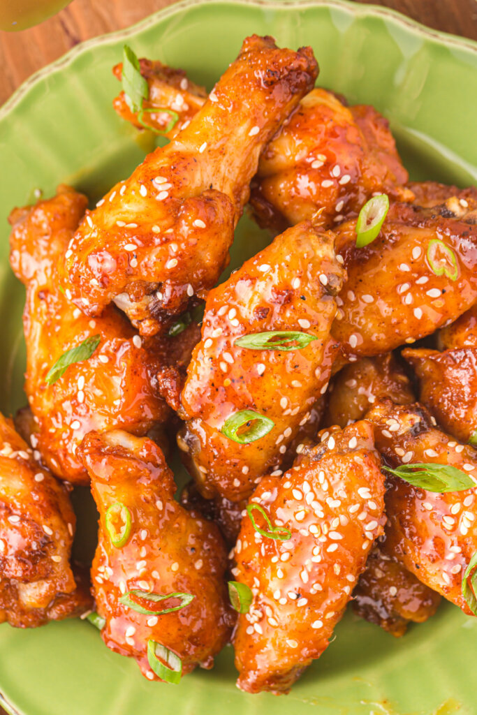 closeup of honey sriracha wings on green plate