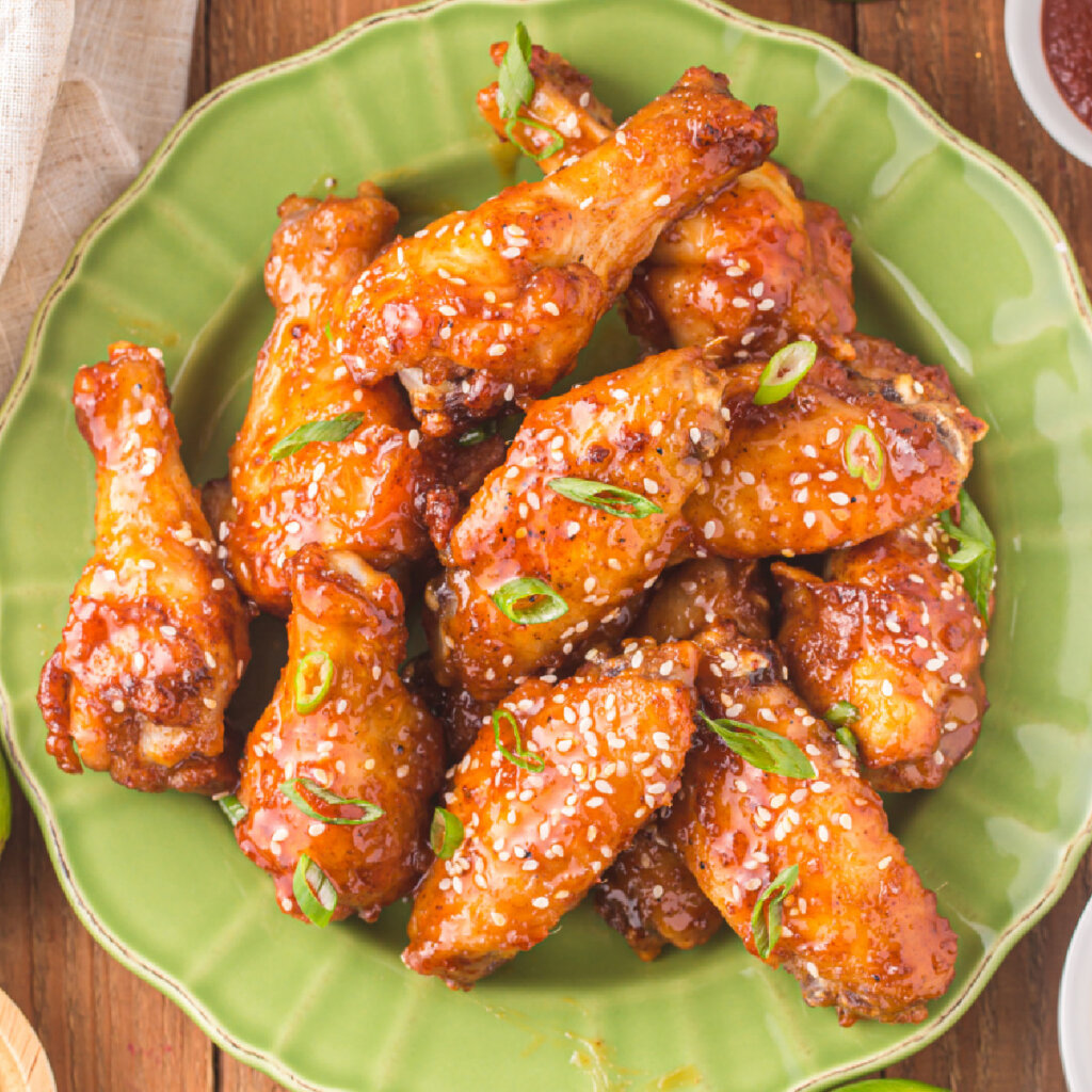 closeup of honey sriracha wings on green plate