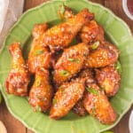 closeup of honey sriracha wings on green plate