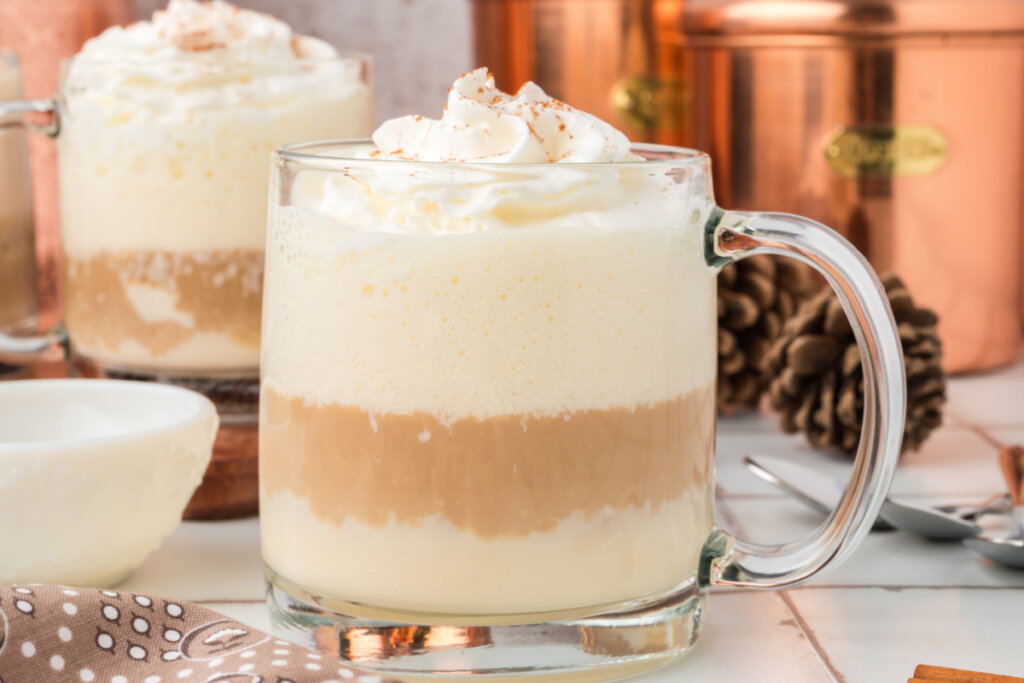 clear mug filled with spiked eggnog latte