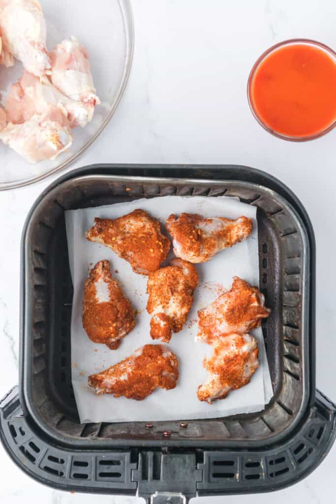uncooked seasoned chicken wings in air fryer
