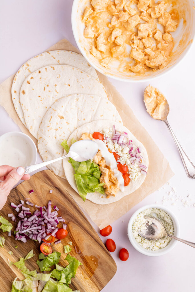 assembling a buffalo chicken wrap