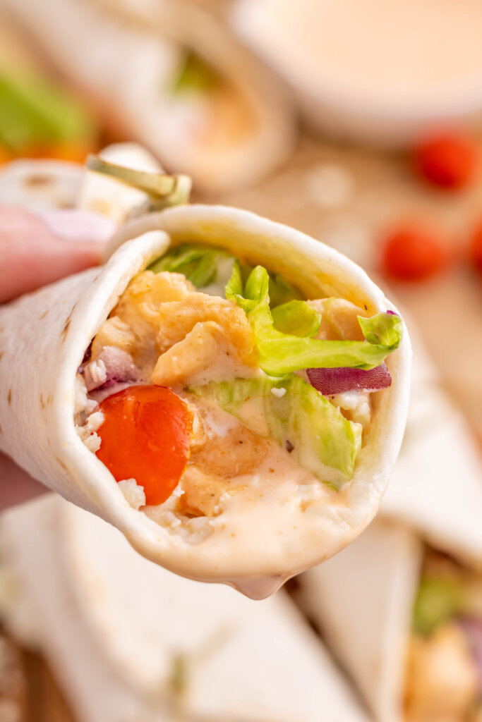 hand holding a buffalo chicken wrap