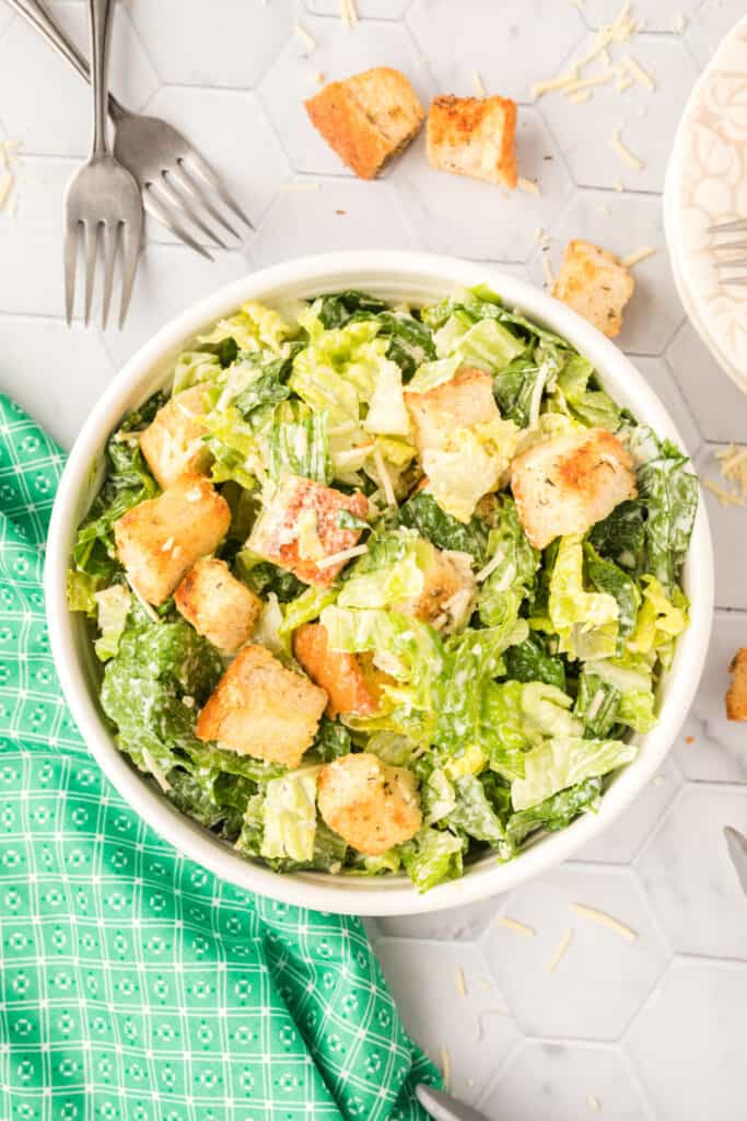 caesar salad in white bowl