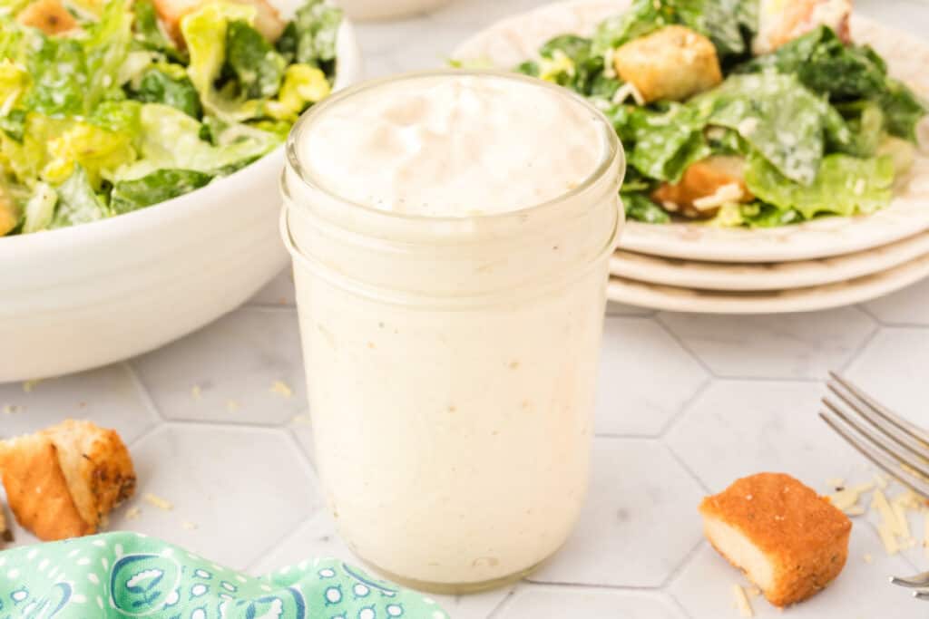 glass jar filled with caesar dressing