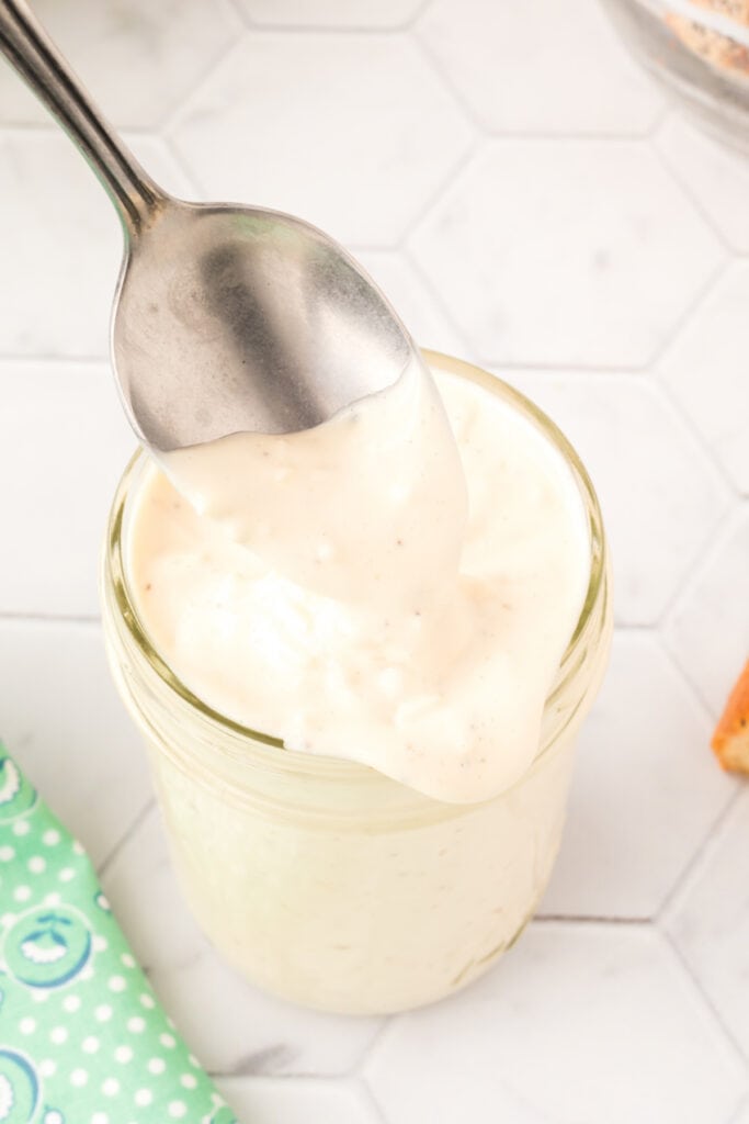 spoon scooping dressing out of jar