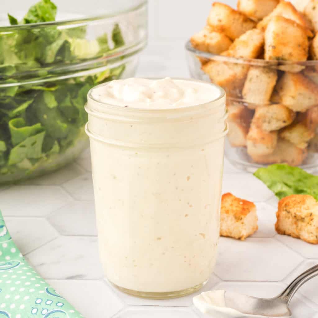 homemade caesar salad dressing in glass jar