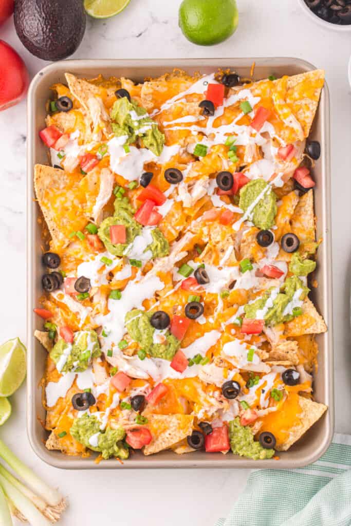 looking down onto a sheet pan filled with chicken nachos