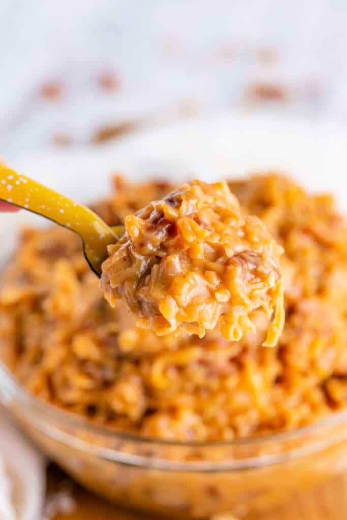 closeup of coconut pecan frosting on a spoon