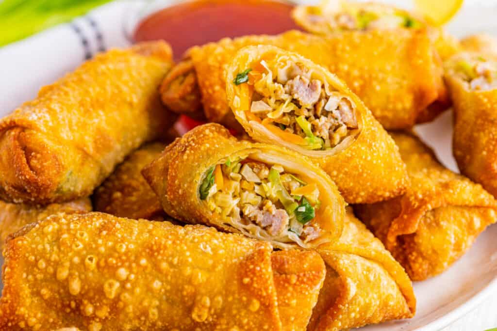 platter of crispy fried egg rolls stacked ready to eat