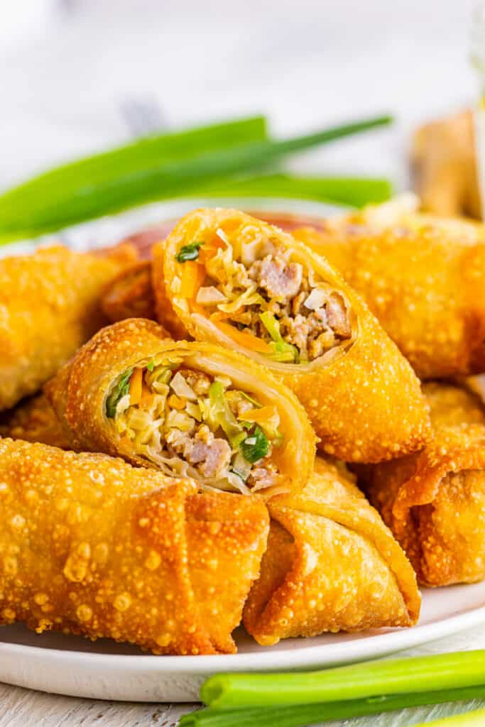 crispy golden ground pork egg rolls on platter