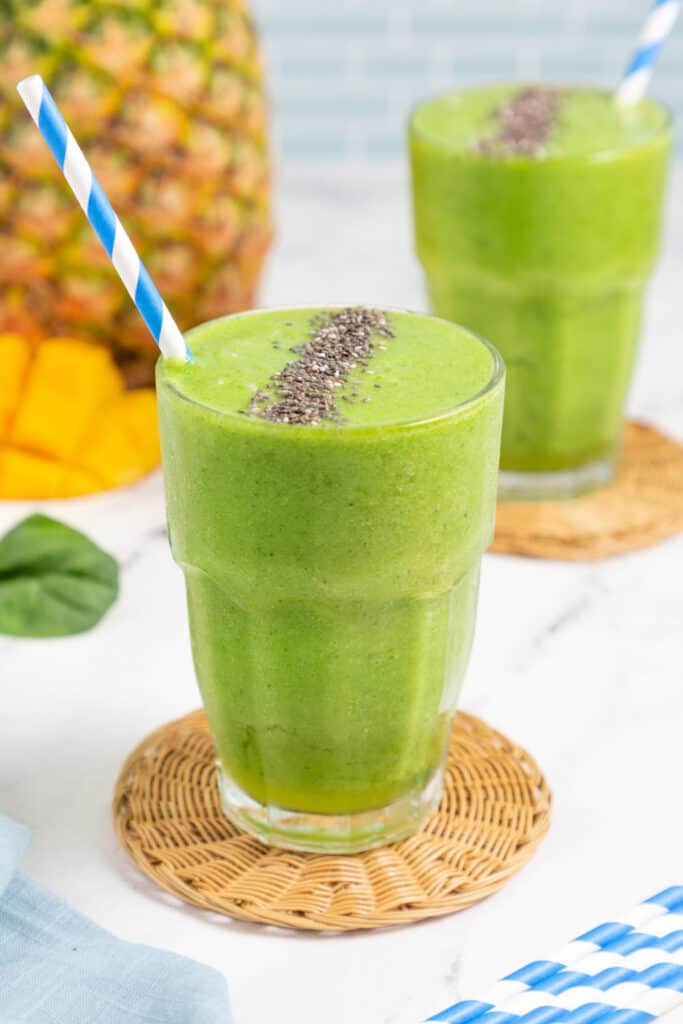 glass filled with pineapple green smoothie