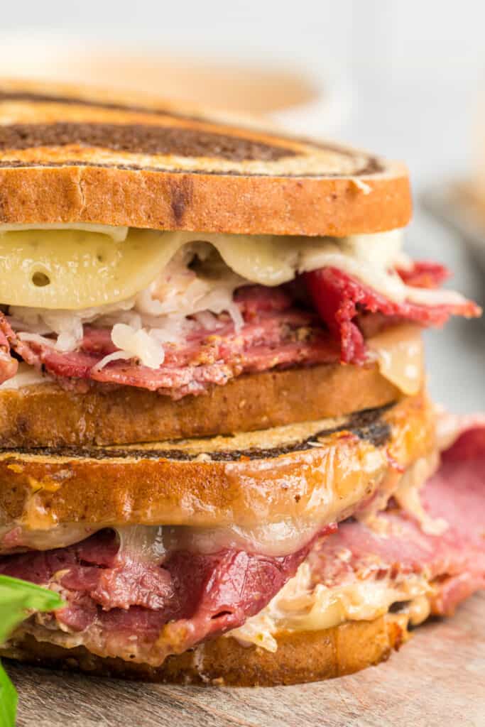 closeup of two reuben sandwiches stacked