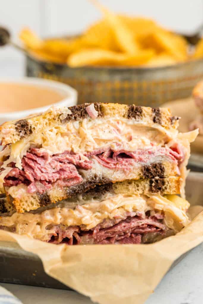 reuben sandwich halves stacked in deli basket