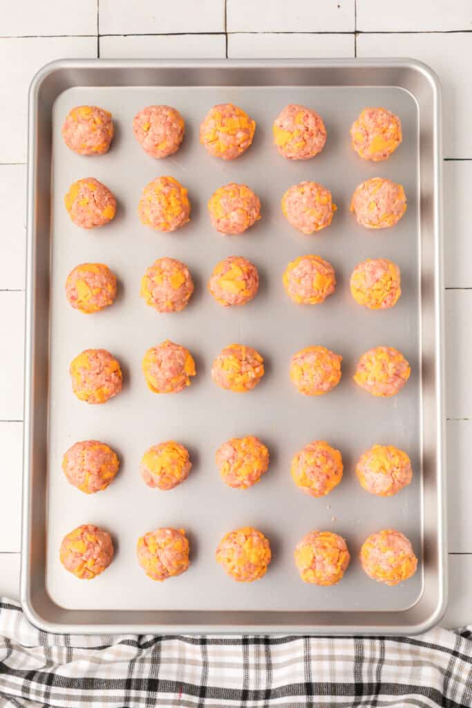 Scoop and roll the mixture into walnut-sized balls and place them on a baking sheet. 