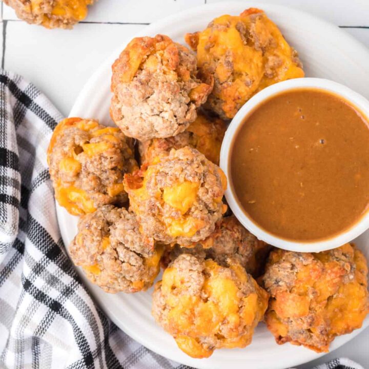 closeup of sausage balls with dip on plate