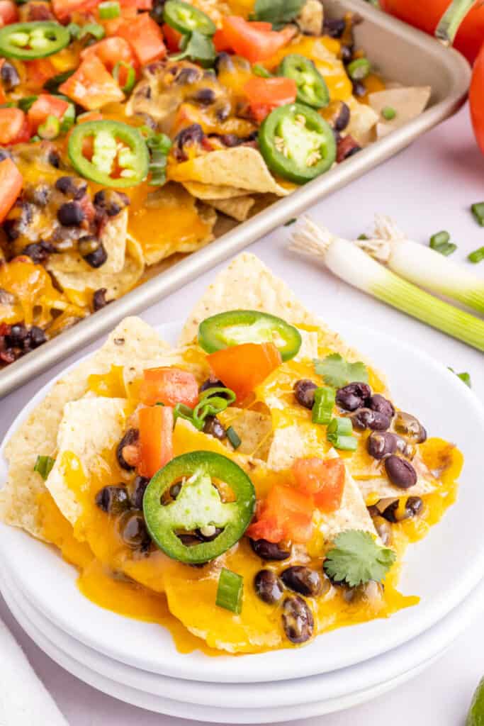 portion of loaded spicy black bean nachos on plate