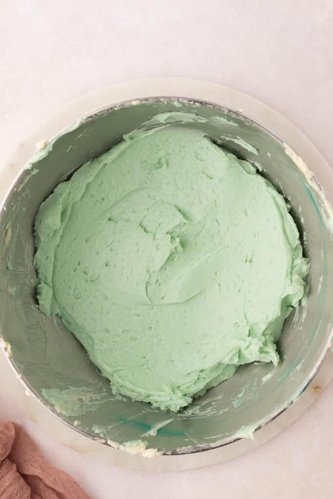 and briefly beat until the buttercream is a uniform color. Transfer the buttercream to a piping bag fitted with a tip. Pipe the buttercream on top of the cooled cake or cupcakes. 