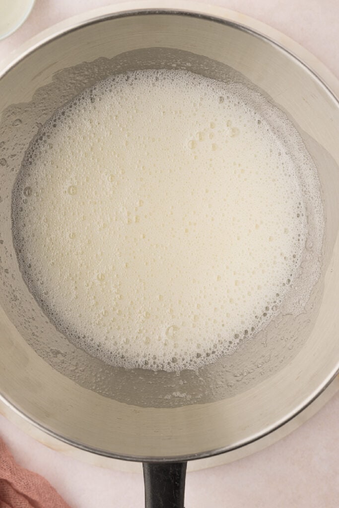 Use a whisk to beat the mixture continuously for 4-5 minutes. The mixture will look frothy. Dip your finger into the mixture and feel it between your fingers. If you can feel any grain, keep heating and mixing until you feel the mixture is smooth and slippery. This means the sugar has dissolved.