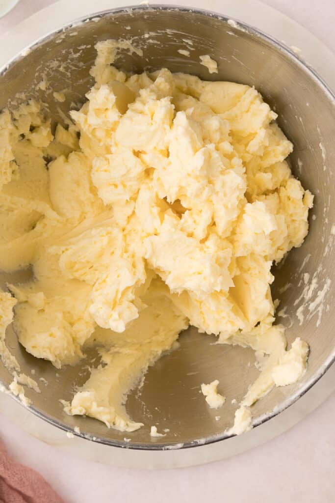 Add the vanilla extract and keep the mixer running until the mixture comes together into a silky smooth Swiss Meringue Buttercream.