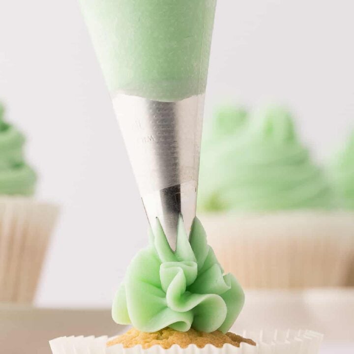 closeup of swiss meringue buttercream being piped
