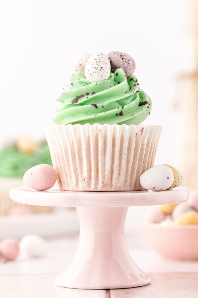 vanilla easter cupcake on a cupcake stand