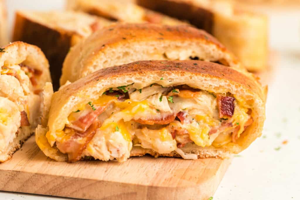 closeup of cheesy chicken bacon ranch bread on cutting board