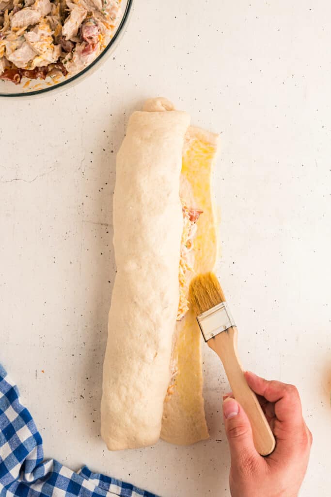 brushing beaten egg along one long edge of each dough.