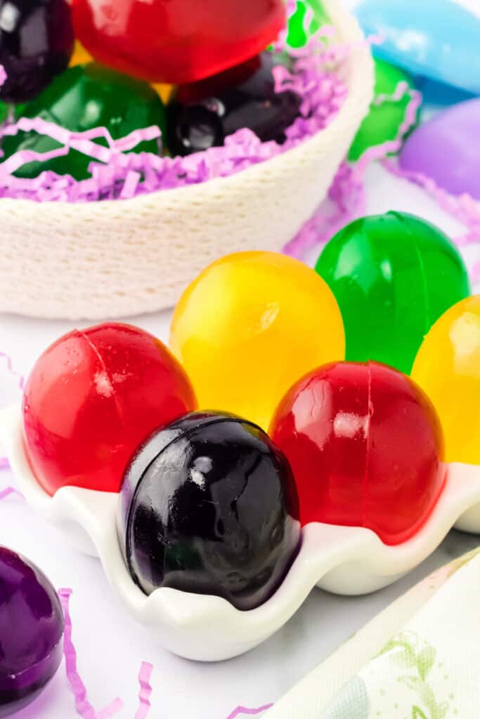 different colors of easter egg jello shots in egg carton holder