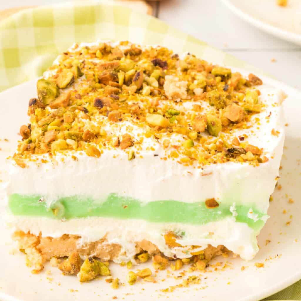 slice of pistachio lasagna lush on plate