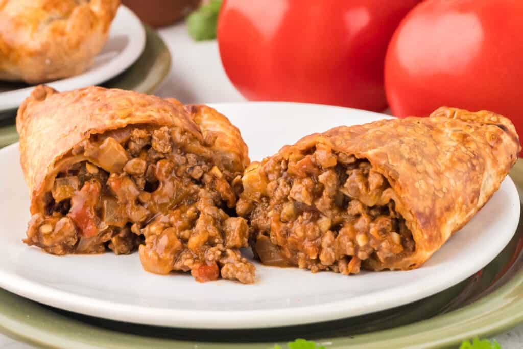 beef empanada split in half to show the beefy inside